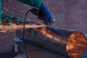 welding and brazing: The image shows a steel industry operator working with the welding method.